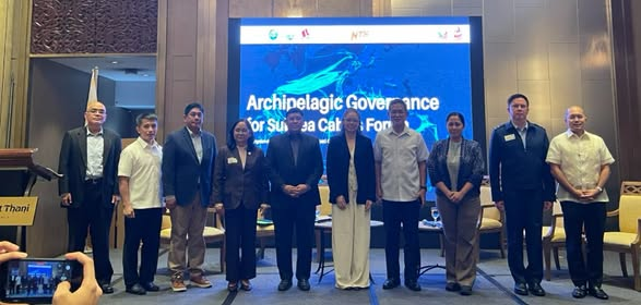Speakers and organizers of the Archipelagic Governance for Subsea Cables Forum standing on stage at Dusit Thani Manila